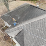 Certified Roof Shield Applicator soft washing a roof before restoring it with Roof Reboot by Roof Shield.